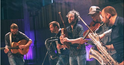 WÖR musicians playing a variety of instruments.